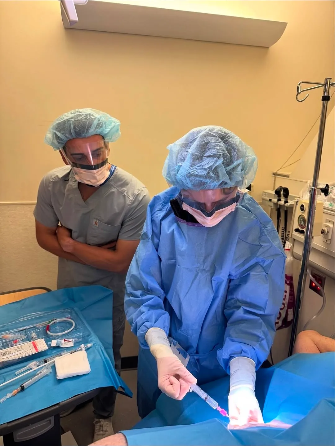 A PGY2 resident performing a bedside procedure